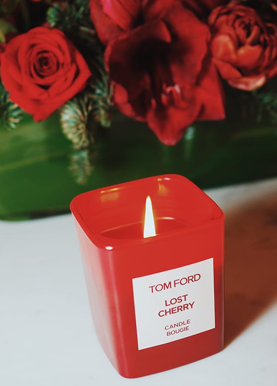 Tom Ford Lost Cherry Candle burning next to roses